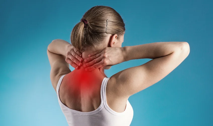 Woman holding the back of her neck